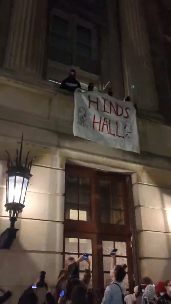 Columbia students take over Hamilton Hall as done in 1968 and unfurl a banner that reads 