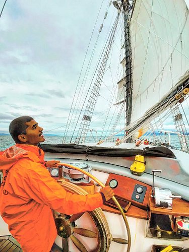 Aaron Vinod John, at just 16 years old, helming a 123-foot tall ship — bound for Great Barrier Island, New Zealand. Wind in t...