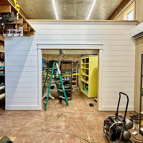 A shiplap wall with cased opening at the souvenir shop to identify the home furnishings section

@latitude29surfshop 
#crysta...
