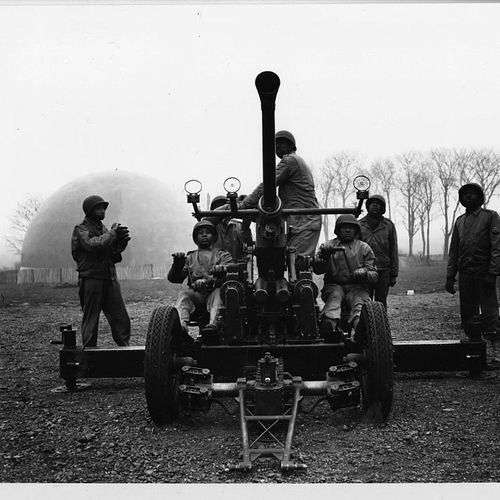 Original caption: “Members of the 450th AA Battery are undergoing an intensive course of AA gunnery. They are under the instr...