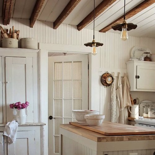 This kitchen is just so calming and cozy! Can't beat warm whites and dark wood (in my opinion!), plus those light fixtures!!!...