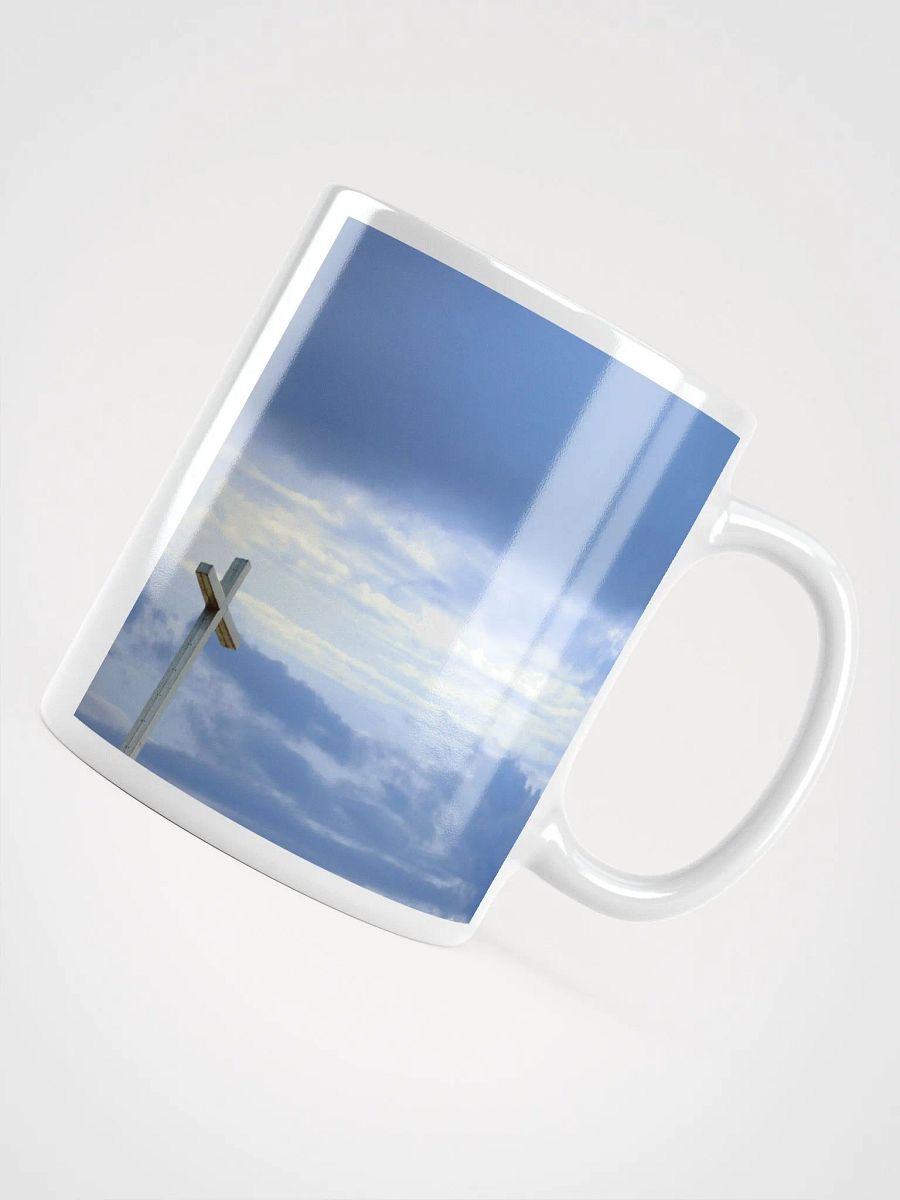 Wooden cross standing atop a rocky hill or mountain, under a sky filled with soft clouds & warm sunlight & cross standing against a dramatic sky with layers of clouds Mug product image (6)