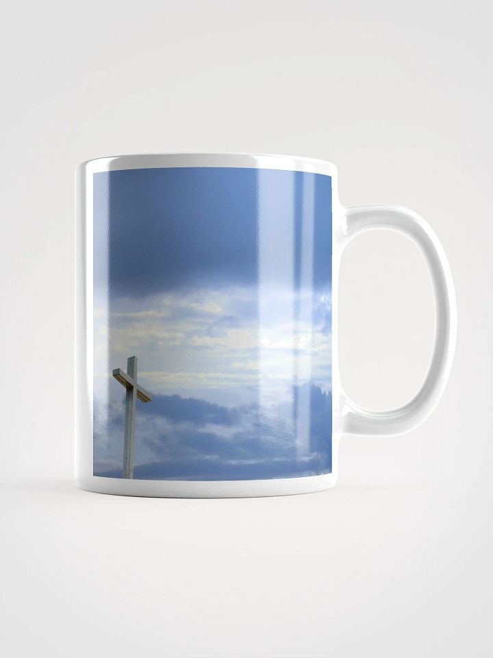 Wooden cross standing atop a rocky hill or mountain, under a sky filled with soft clouds & warm sunlight & cross standing against a dramatic sky with layers of clouds Mug product image (1)