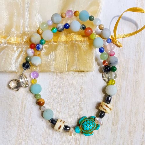 I made this bracelet for my daughter from a stretch bracelet she had. I kept the turtle charm and some of the sea stones, str...