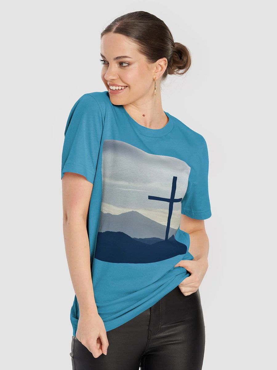 A cross standing against a serene landscape of rolling hills and distant mountains under a soft, cloudy sky t-shirt product image (3)