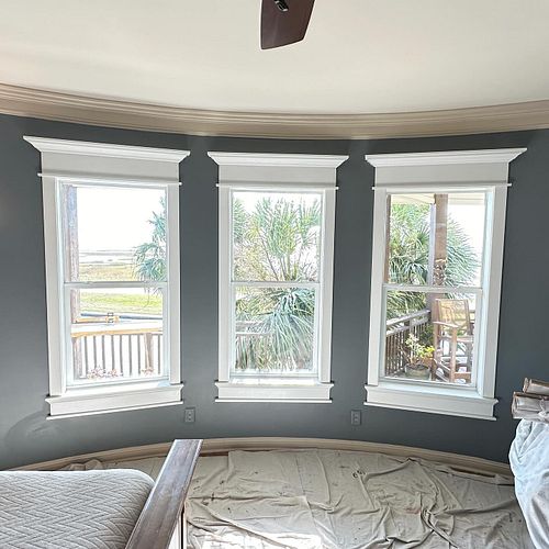 A handsome trio of window treatments along a curved wall just to keep me on my toes