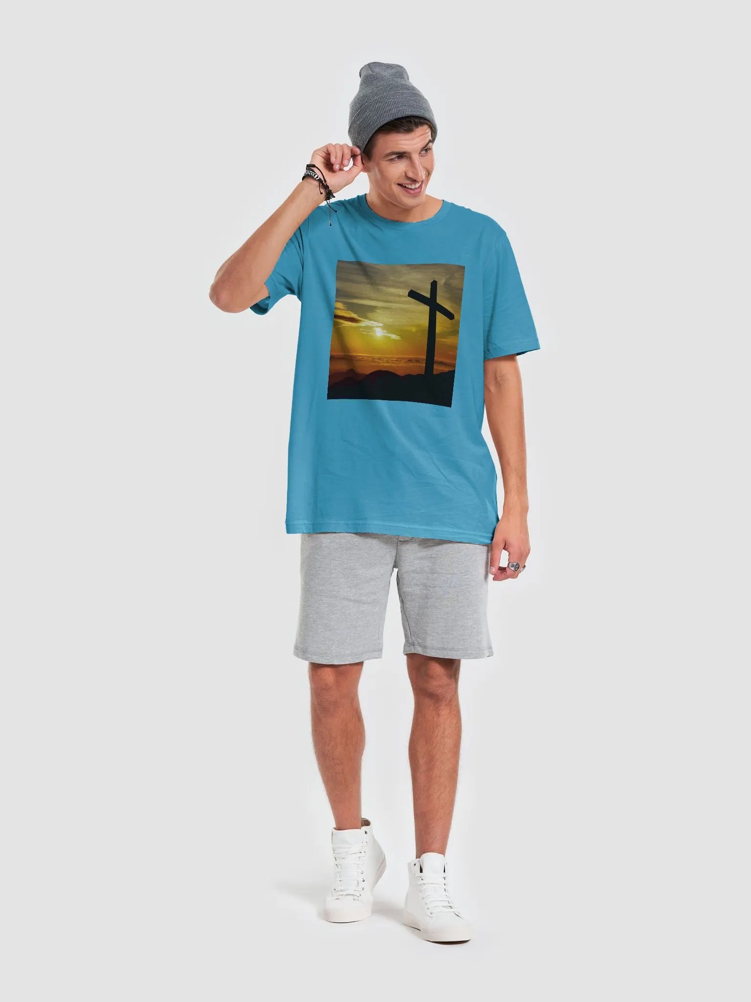 Large cross silhouetted against a dramatic sunset, vibrant hues of yellow, orange, dominate the sky, with clouds and distant mountains t-shirt product image (7)