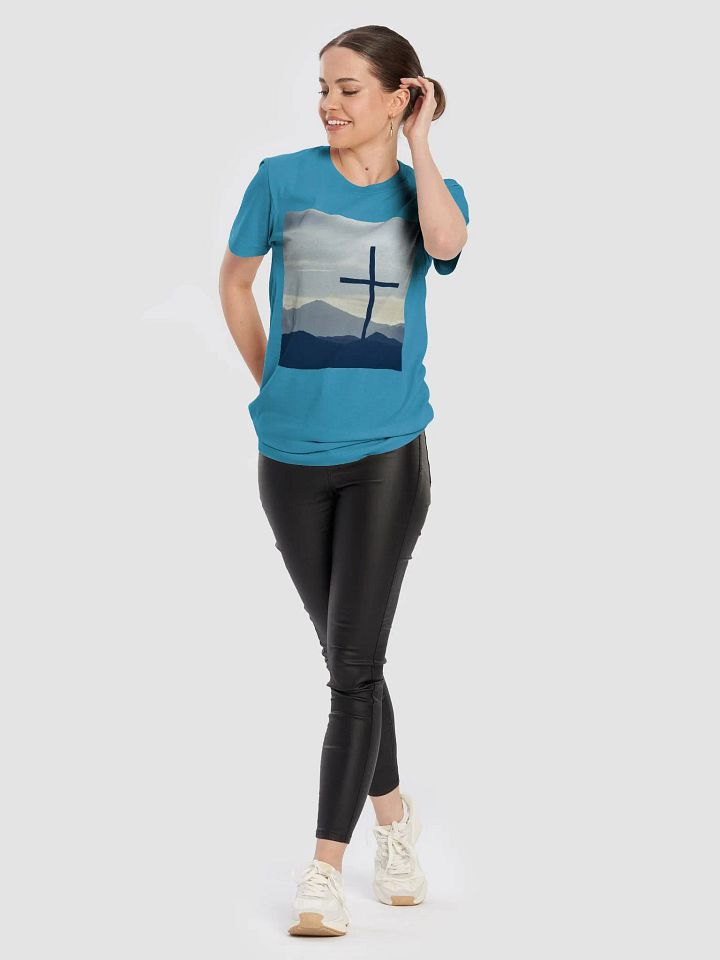 A cross standing against a serene landscape of rolling hills and distant mountains under a soft, cloudy sky t-shirt product image (2)