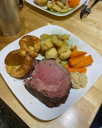 Finished Prime Rib with Yorkshire Pudding, roasted potatoes, carrots and even parsley dust.