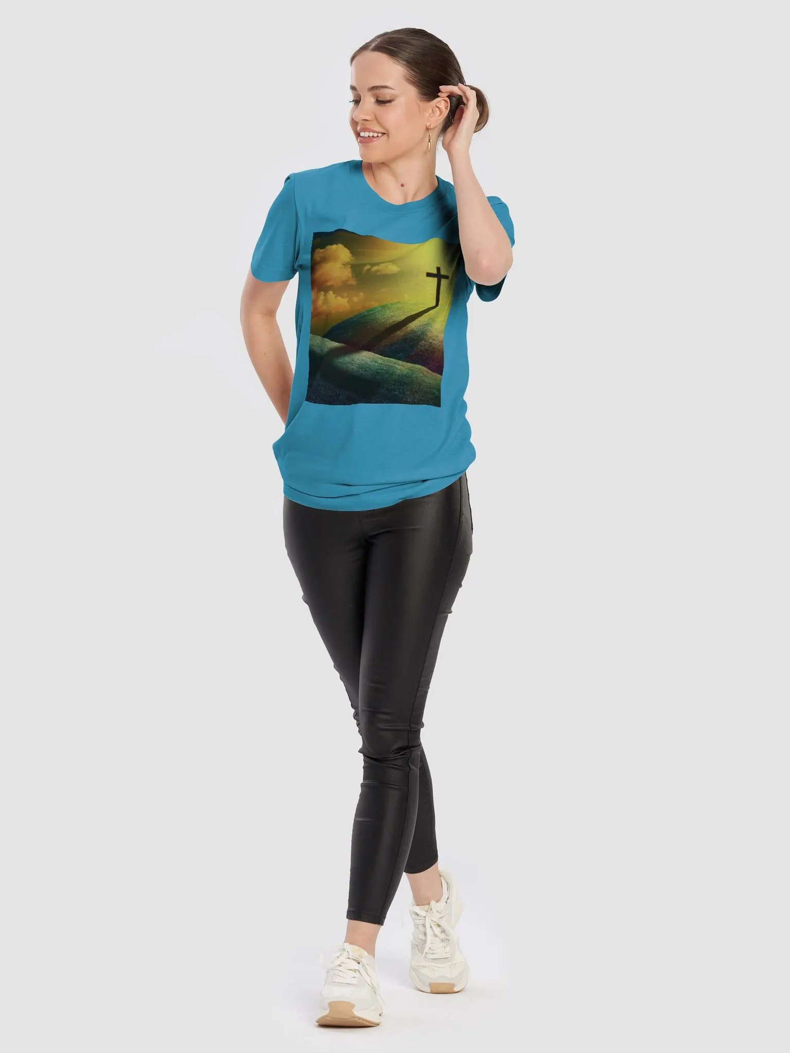 A cross standing prominently on a grassy hill, with a vivid, dramatic background t-shirt product image (10)