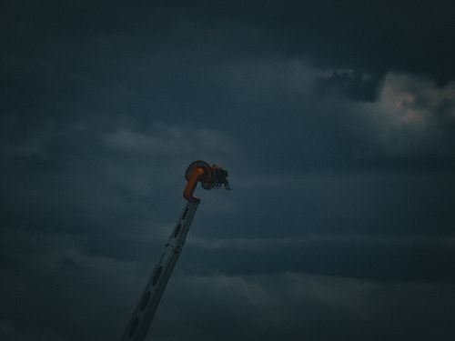 Defying gravity against the dark skies. 🎢 This thrilling shot is available as a framed print in my Fourthwall store or as a d...