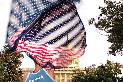 A protester waving a flag in front of the U.S. Capitol building in Washington, D.C.

#capital #washington #dc #flag
