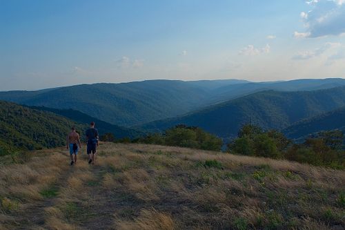 A couple of hikers on a mountaintop meadow overlooking the Savage River Reservoir in Maryland.

#maryland #mountains #hiking