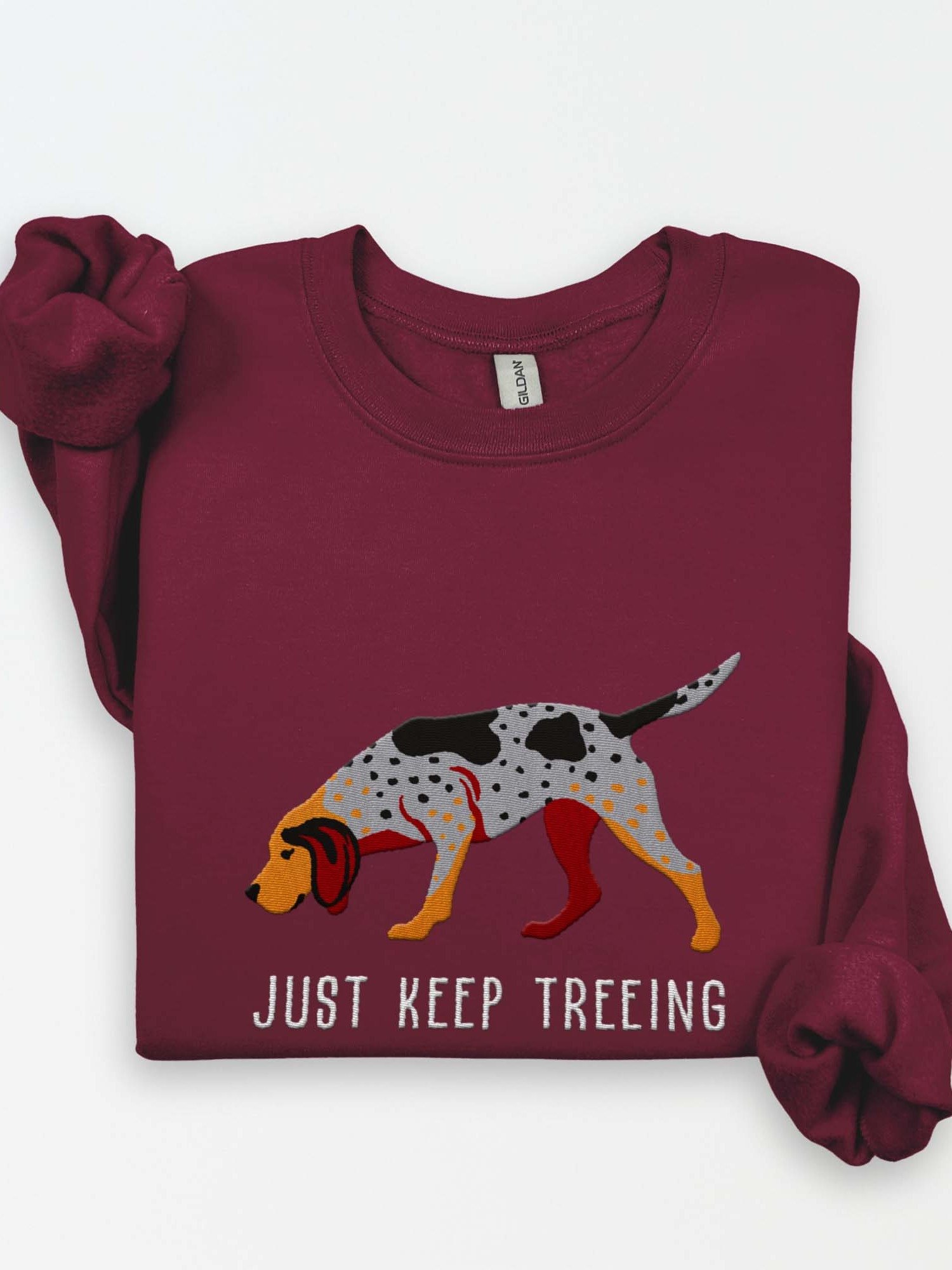 Just Keep Treeing Sweatshirt (Embroidered) of an American English Coonhound product image (1)