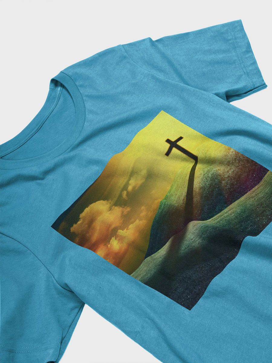 A cross standing prominently on a grassy hill, with a vivid, dramatic background t-shirt product image (5)