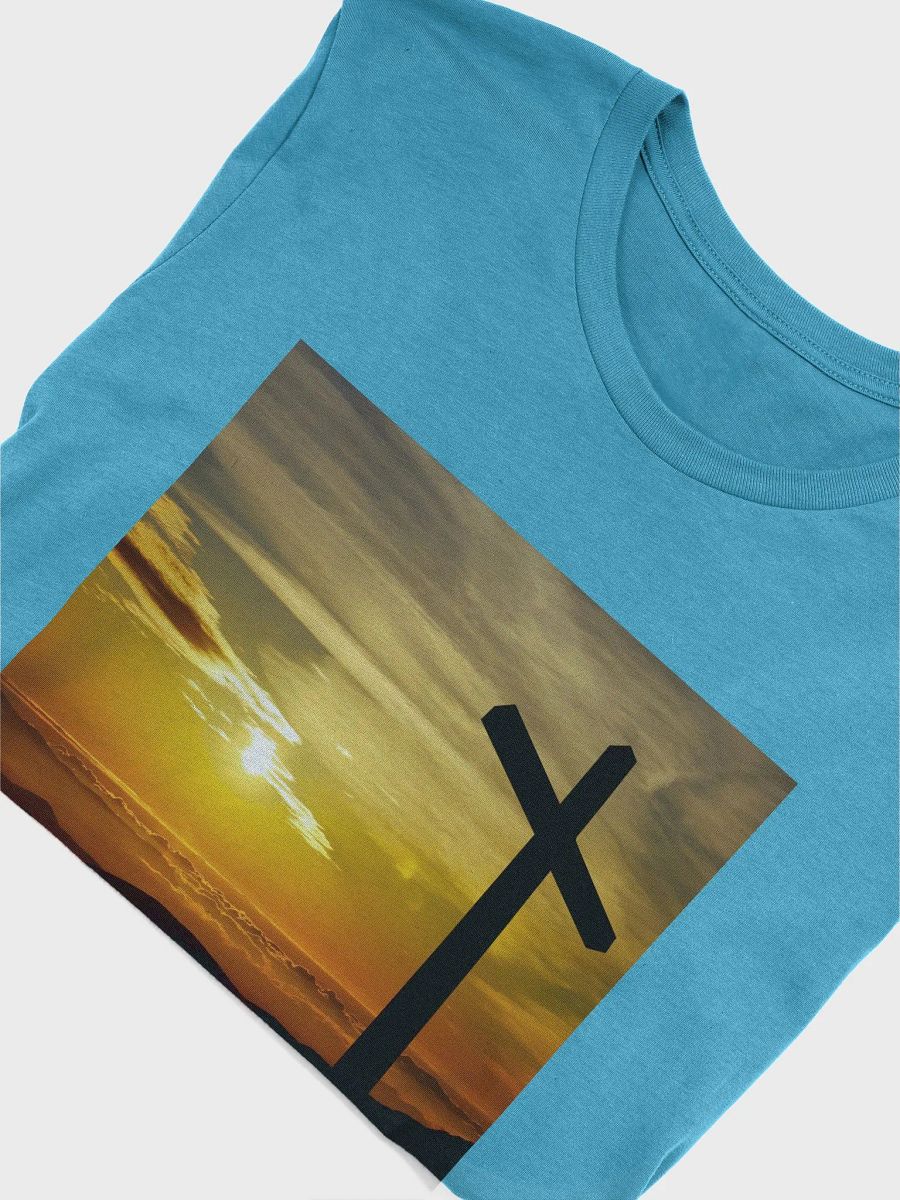 Large cross silhouetted against a dramatic sunset, vibrant hues of yellow, orange, dominate the sky, with clouds and distant mountains t-shirt product image (3)