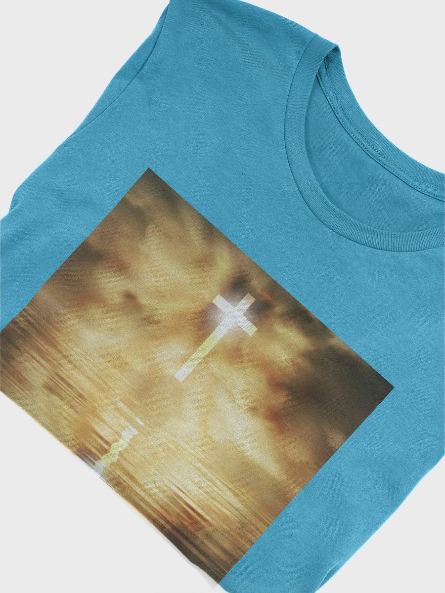 Glowing cross illuminated by intense golden light, reflecting on calm water below t-shirt product image (10)