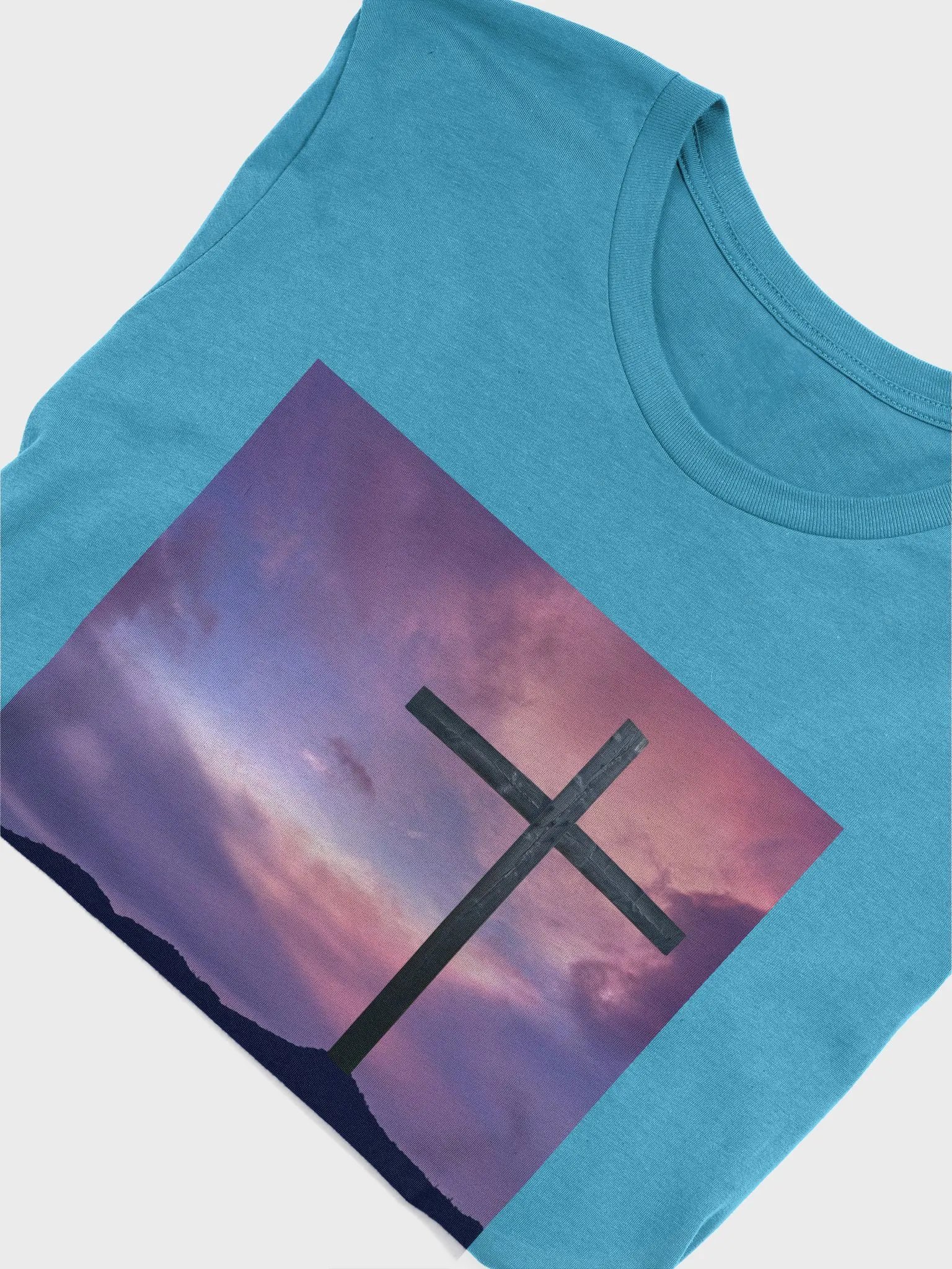 Wooden cross standing on a hill, silhouetted against a vibrant and colorful sky transitioning from deep purples to pinks t-shirt product image (4)