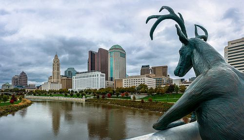A bronze deer sculpture looks over the Scioto River at downtown Columbus, Ohio from the Rich Street Bridge.

#columbusohio #o...