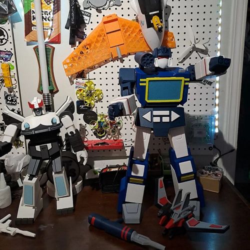 Soundwave standing with his tape deck and lazerbird