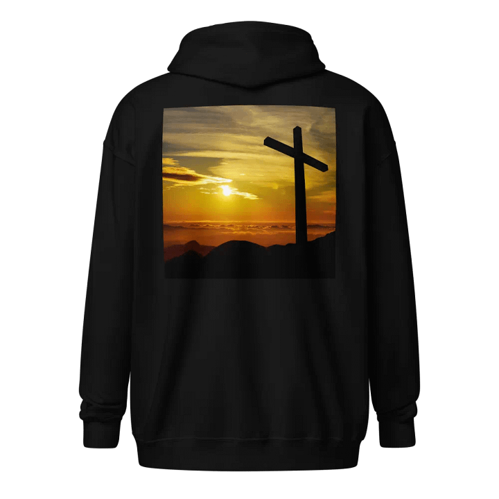 Large cross silhouetted against a dramatic sunset, vibrant hues of yellow, orange, dominate the sky, with clouds and distant mountains Hoodie product image (1)