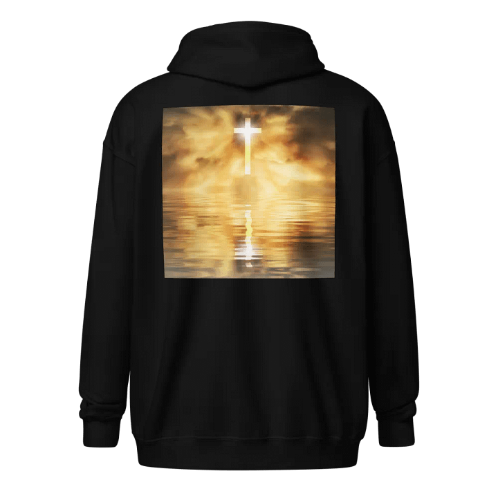 Glowing cross illuminated by intense golden light, reflecting on calm water below Hoodie product image (1)