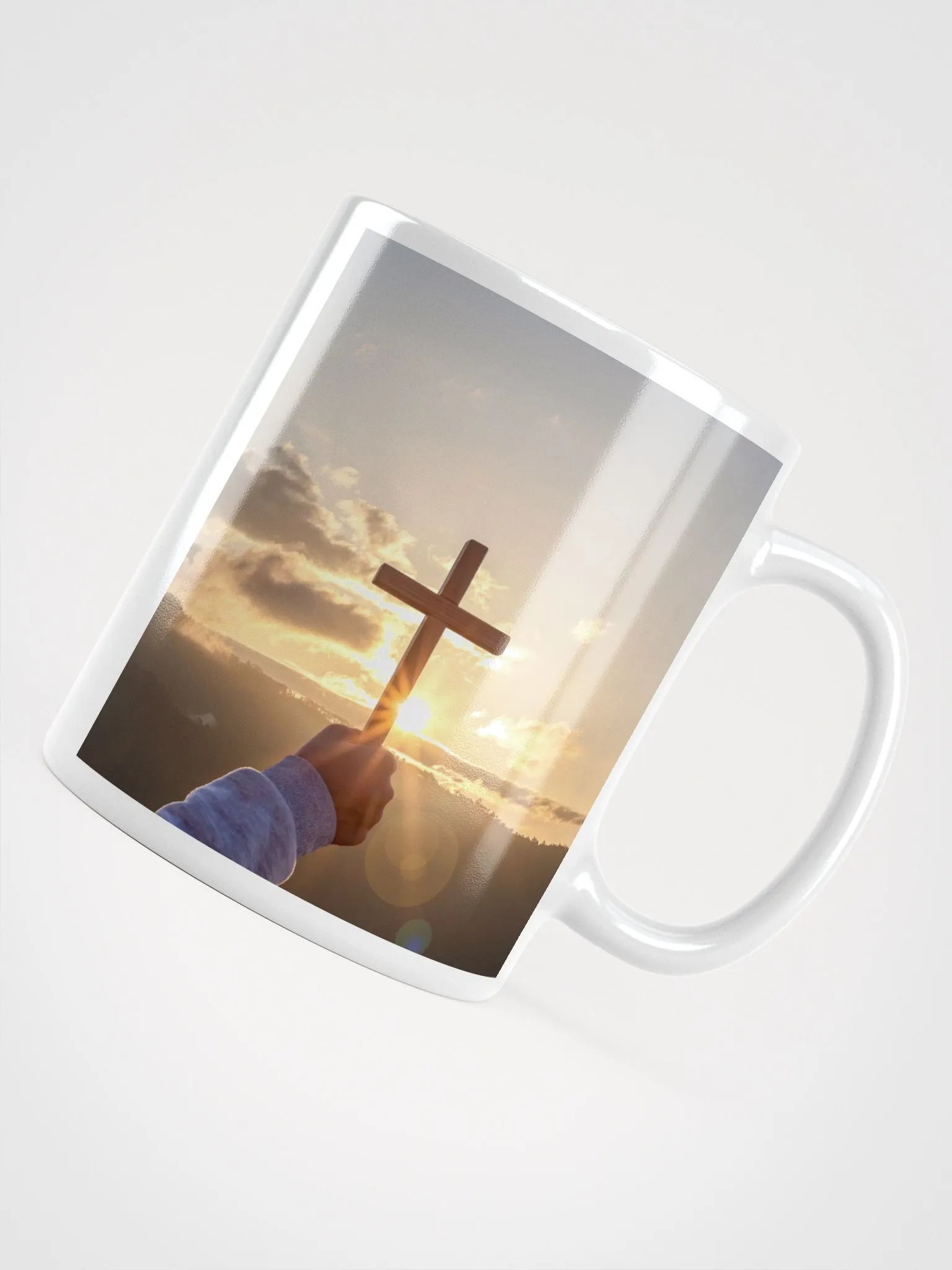 Cupped hands holding a glowing cross silhouette & Wooden cross being held up against the backdrop of a sunrise Mug product image (4)