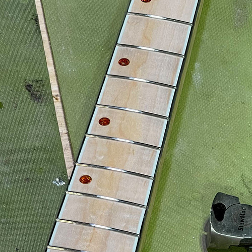 Frets in, dots in, neck mostly carved. Still need side dots. No level or dress yet, frets just roughed in. Decent day. 

.
.
...