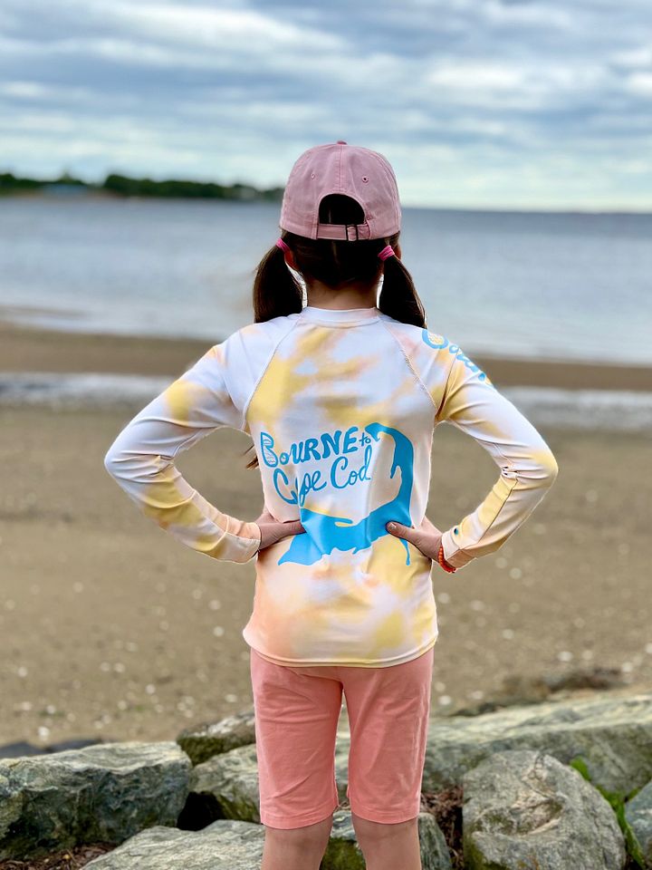 YOUTH | Rash Guard | BRN.2C.C.™ Front Graphic | BOURNE to Cape Cod™ Sleeve & Back Logo | Coastal Swim Shirt for Kids | UV Protection Activewear | Blue Logo on Orange Tie-Dye product image (2)