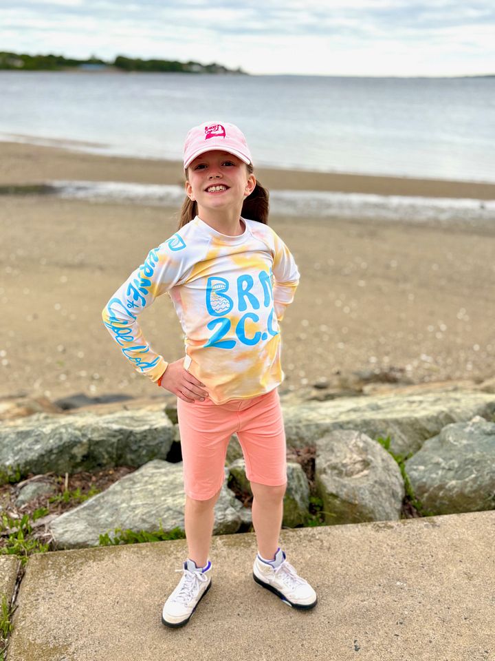 YOUTH | Rash Guard | BRN.2C.C.™ Front Graphic | BOURNE to Cape Cod™ Sleeve & Back Logo | Coastal Swim Shirt for Kids | UV Protection Activewear | Blue Logo on Orange Tie-Dye product image (1)