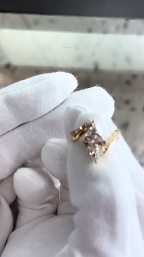 A beautifully handcrafted marquise-cut diamond engagement ring, paired with a perfectly fitted jacket-style wedding band for ...