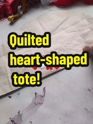 I really love this bag, I'm enjoying bag making. A red harness would elevate this outfit. 🍓 @°•♡𝓛𝓮𝓪 ♡•°  video description: Showing the bag making process — the pattern, the heart quilting on recycled batting type material, sewing the broderie anglaise frill trim, sewing the red satin lining and sewing the quilted sides and handles. Final image is a Fat Black femme showing off the finished bag styled in a strawberry theme — strawberry dress, earrings, hair accessories and red shoes, mask and Bangle. #quiltedbag  #quiltedheart #sewingtiktok  #vintagestyle  #🍓 