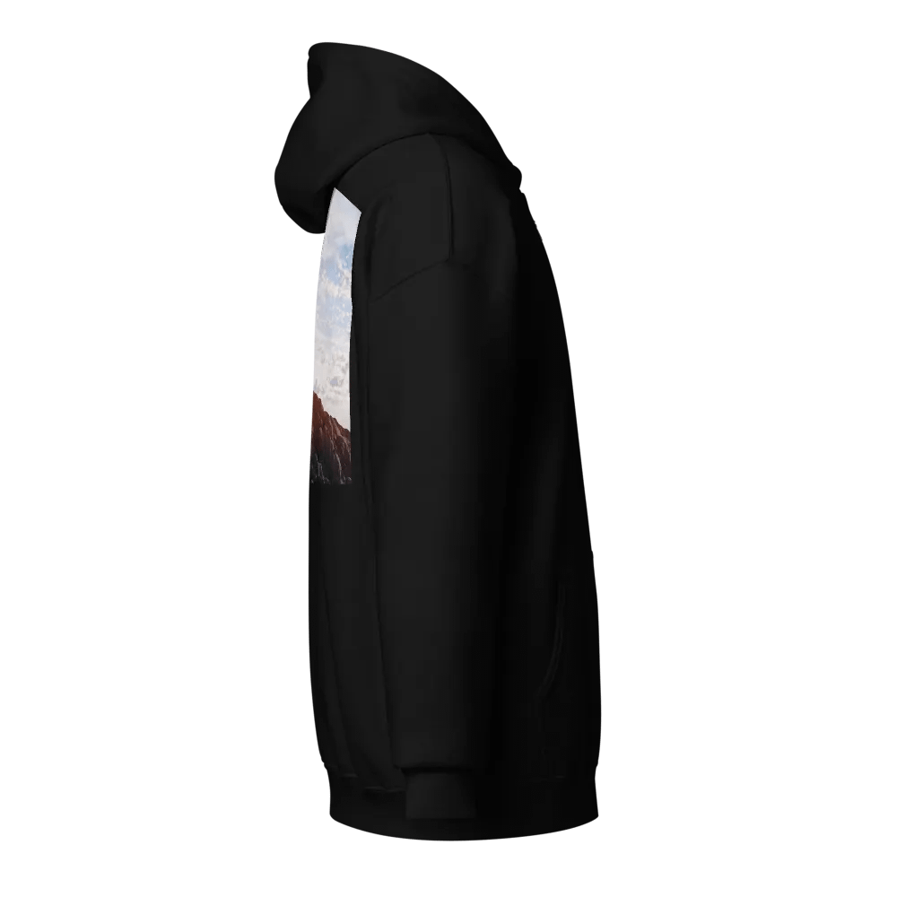 Wooden cross standing atop a rocky hill or mountain, under a sky filled with soft clouds and warm sunlight Hoodie product image (4)