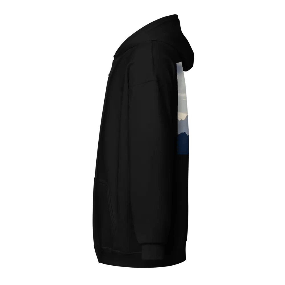 A cross standing against a serene landscape of rolling hills and distant mountains under a soft, cloudy sky Hoodie product image (3)