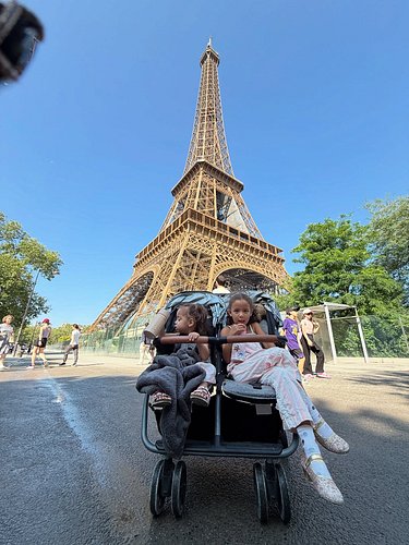 We approached the Eiffel Tower from the side, with the canopy of trees hiding it from site. I told Tatum “I have a surprise f...