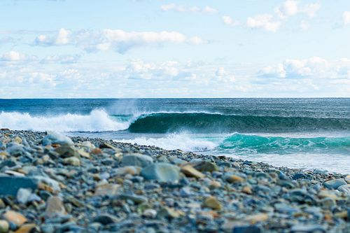 Long empty lefts in a cobble stone cove.