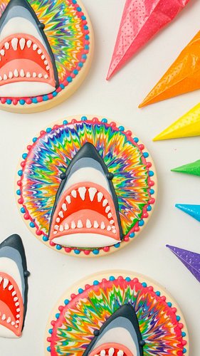 I think rainbow tie dye makes sharks a little less scary 😁

#sugarcookies #decoratedcookies #sweetambscookies #summercookies ...