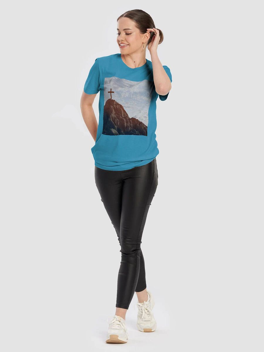 Wooden cross standing atop a rocky hill or mountain, under a sky filled with soft clouds and warm sunlight t-shirt product image (5)