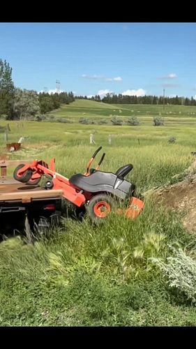 This is a textbook example of how not to unload your lawn mower. Great way to destroy your equipment! Don't be an idiot.