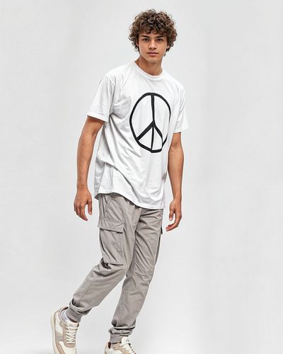 This stylish t-shirt features a bold peace symbol on the front, making a statement of unity and hope. The back of the shirt c...