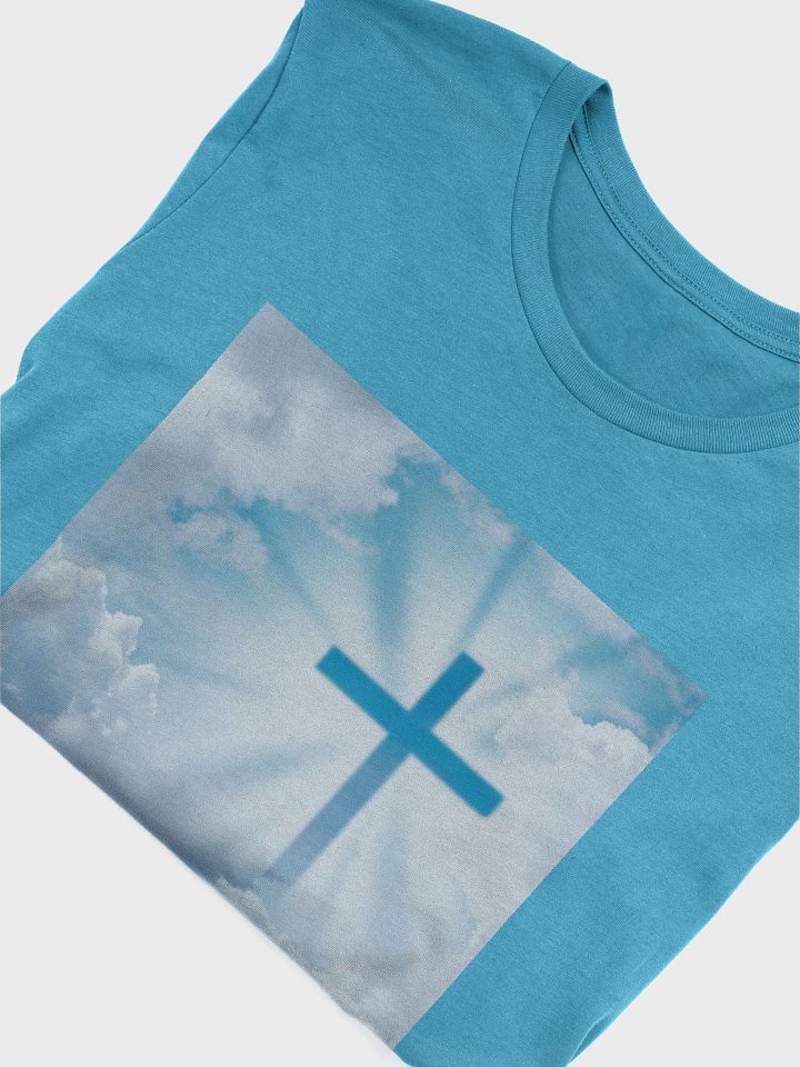 A cross surrounded by a heavenly scene, with rays of light shining through soft clouds in a bright blue sky t-shirt product image (2)