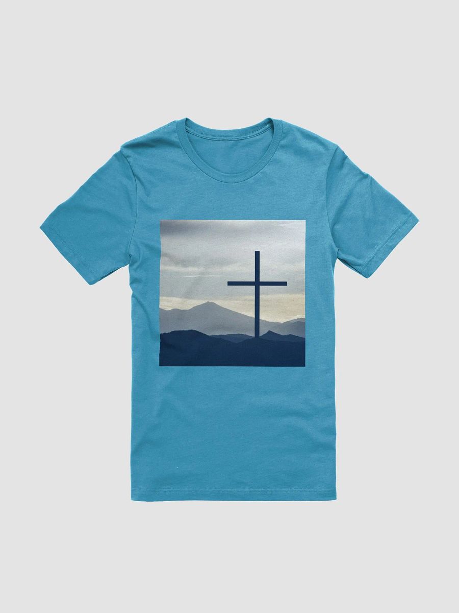 A cross standing against a serene landscape of rolling hills and distant mountains under a soft, cloudy sky t-shirt product image (1)