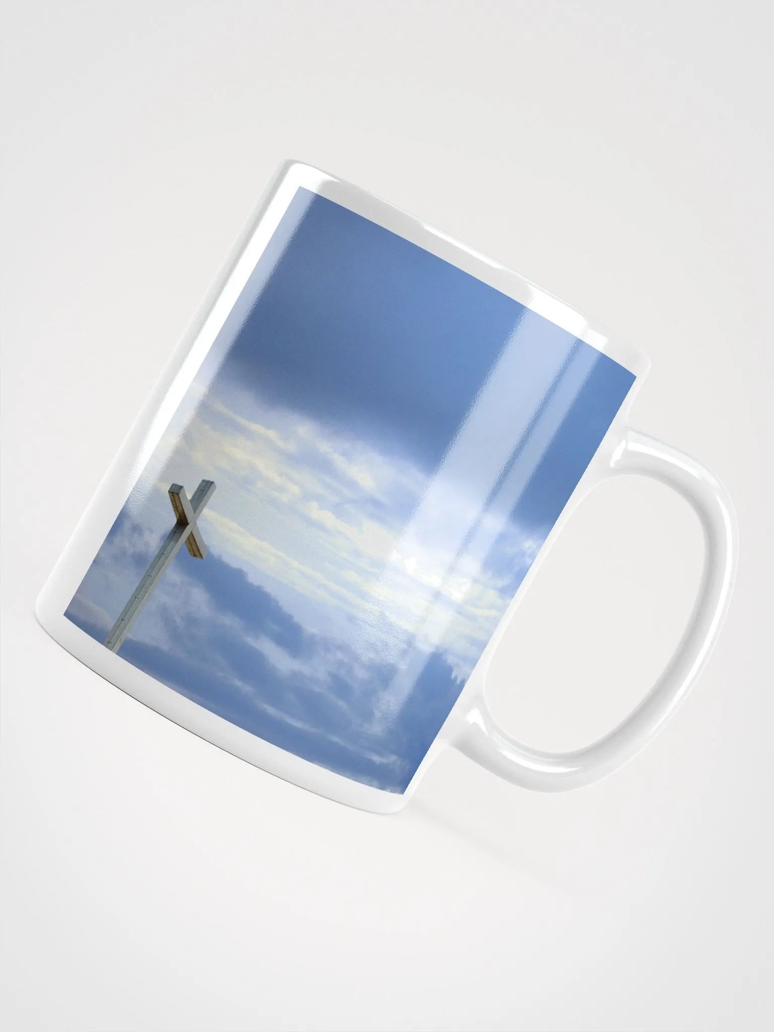 Wooden cross standing atop a rocky hill or mountain, under a sky filled with soft clouds & warm sunlight & cross standing against a dramatic sky with layers of clouds Mug product image (6)